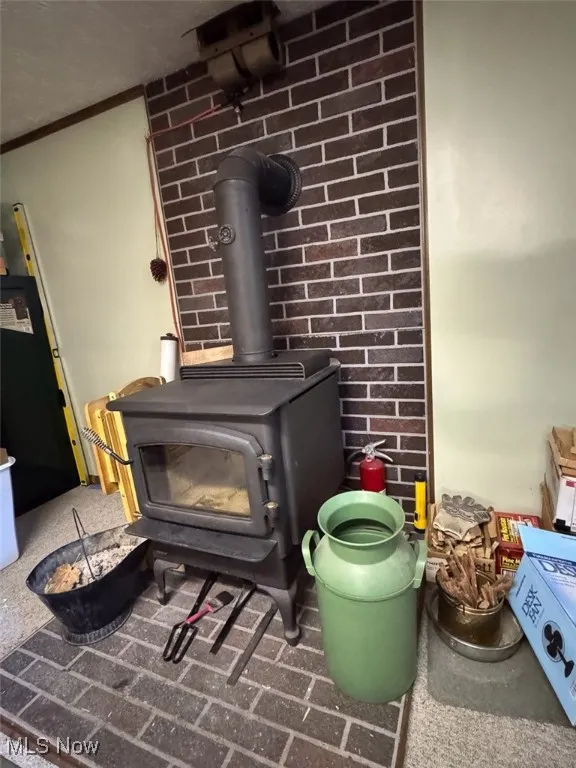 Detailed view of a wood stove and brick wall