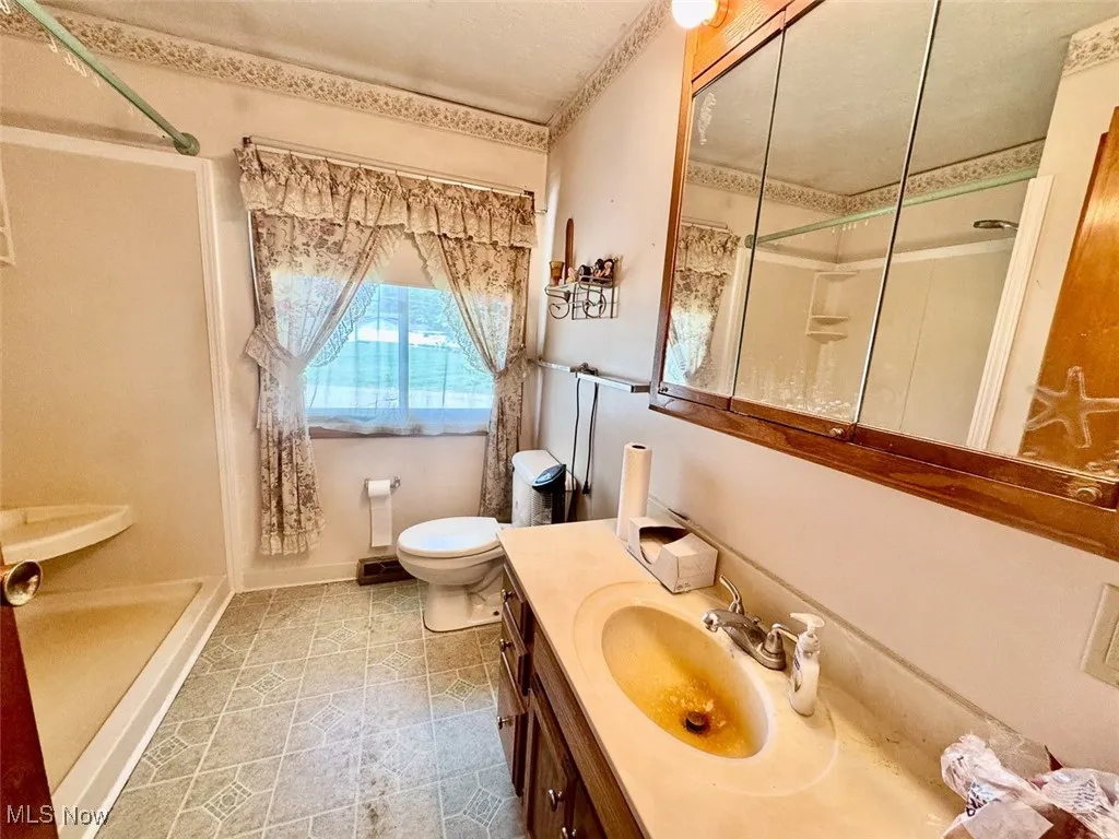 Bathroom with a shower stall and vanity