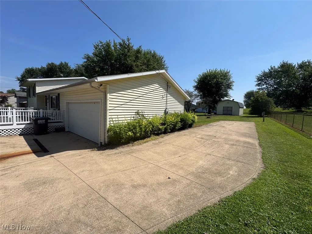 View of home's exterior featuring a garage and driveway
