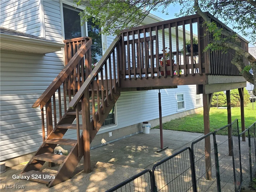 Wooden deck featuring a patio and stairway