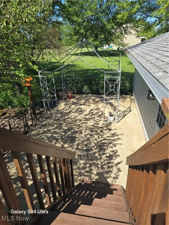 View of wooden terrace to patio below.