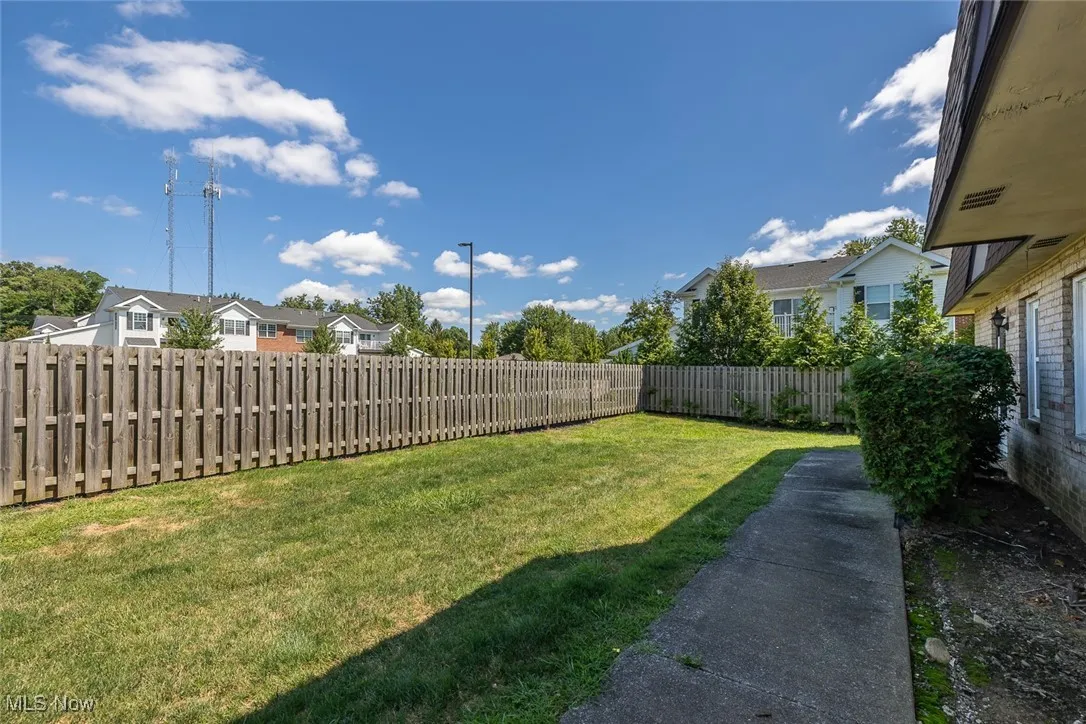 Fenced backyard with a residential view