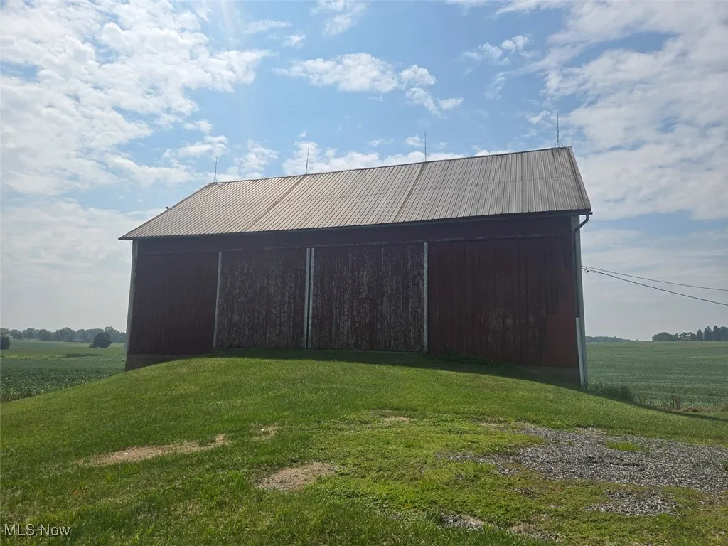 View of outbuilding with a rural view