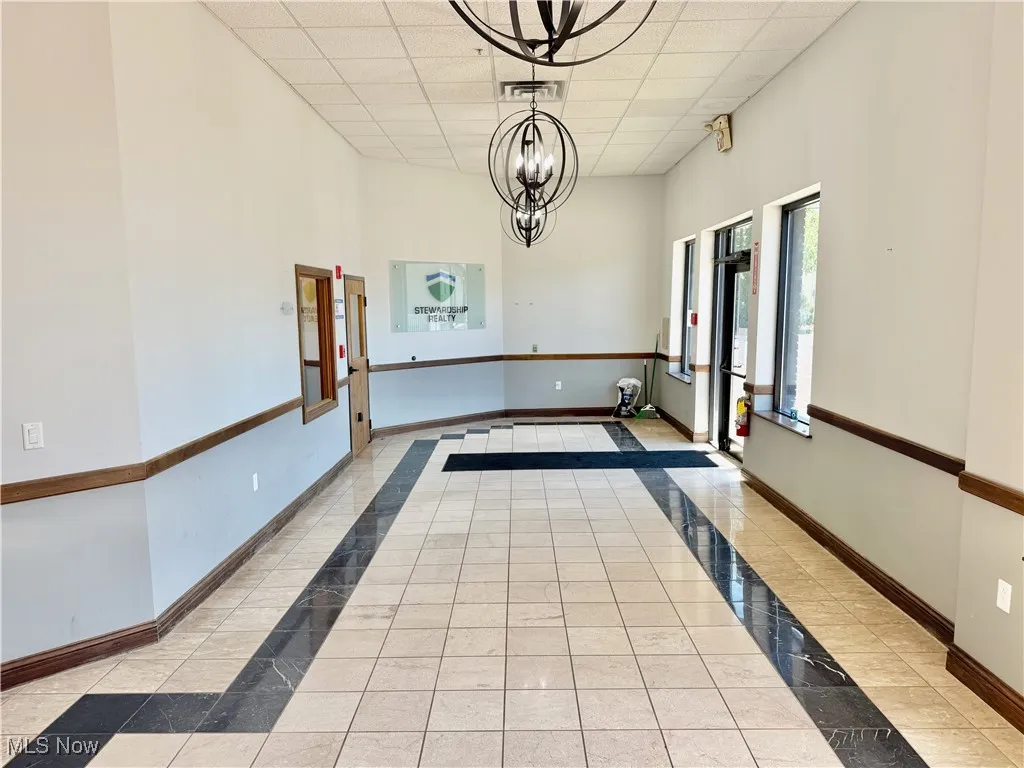 From the other end of the lobby, facing the exit and entrance to the office space.