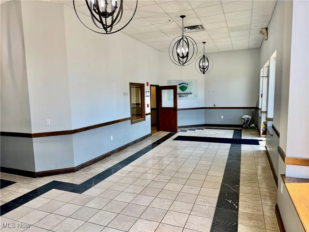 From the other end of the lobby, facing the exit and entrance to the office space.