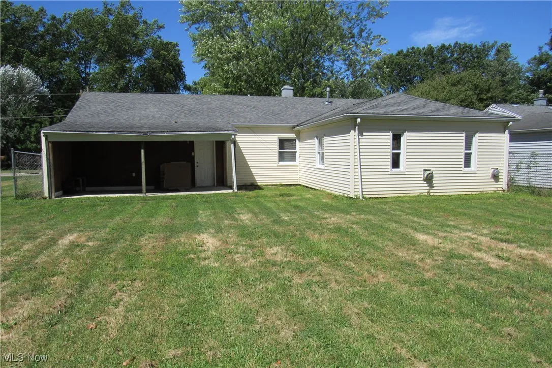 Rear view of house with roof with shingles