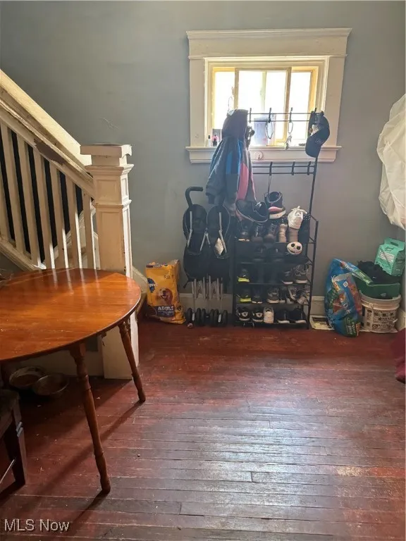 Dining area with dark wood finished floors and stairs