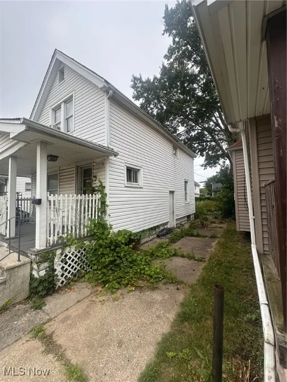 View of property exterior featuring a porch