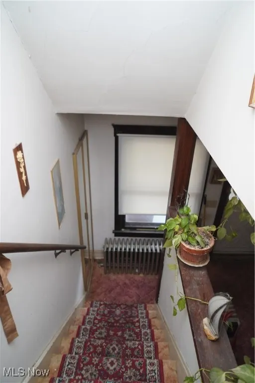 Corridor with radiator and baseboards