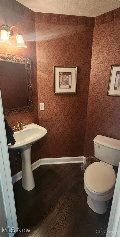Bathroom featuring dark wood-style floors and baseboards
