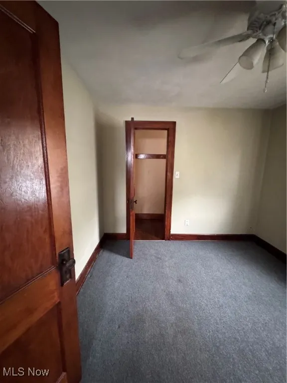 Unfurnished bedroom featuring carpet flooring and a ceiling fan