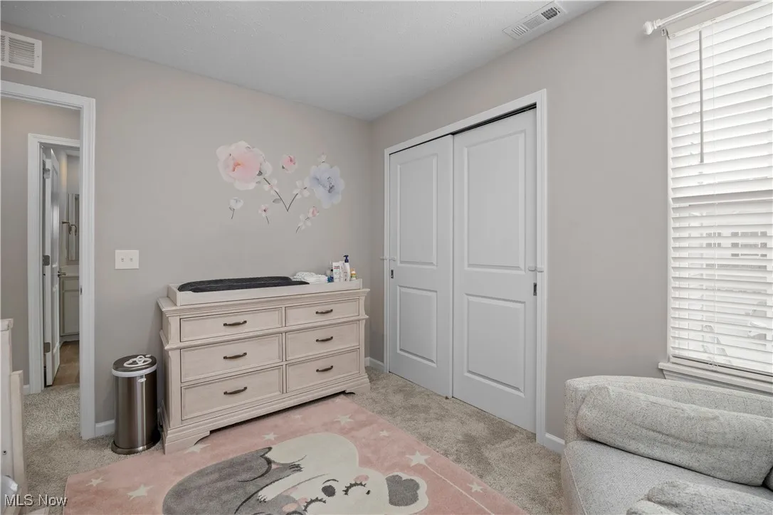 Sitting room featuring light colored carpet