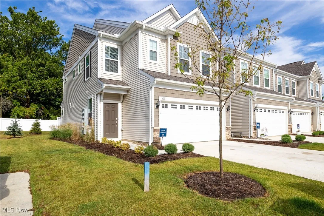 Traditional-style home with an attached garage and driveway