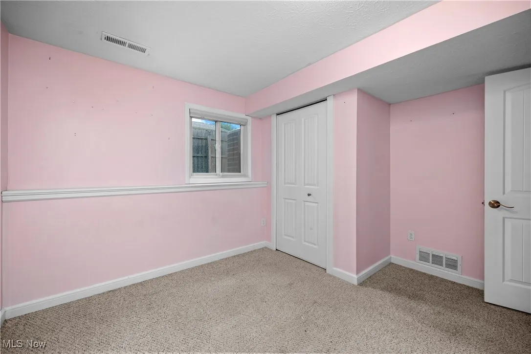 Unfurnished bedroom with carpet and a closet