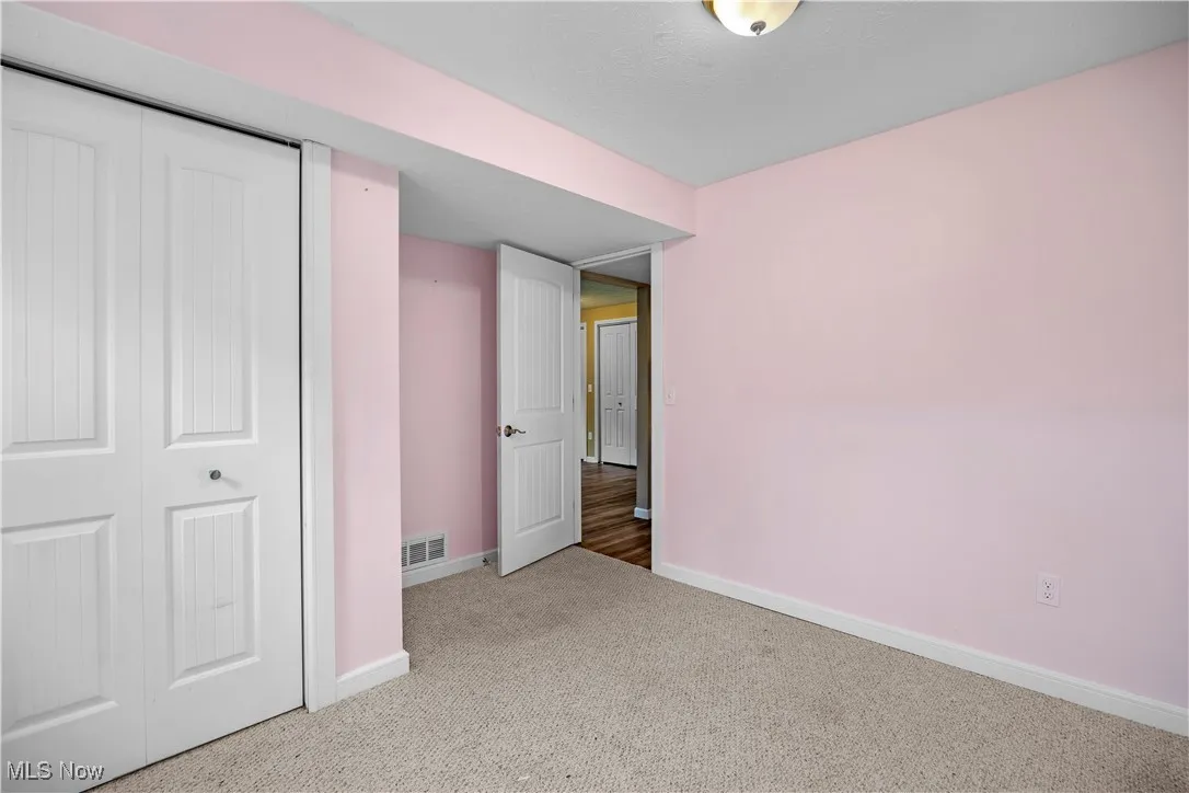 Unfurnished bedroom featuring carpet flooring and a closet