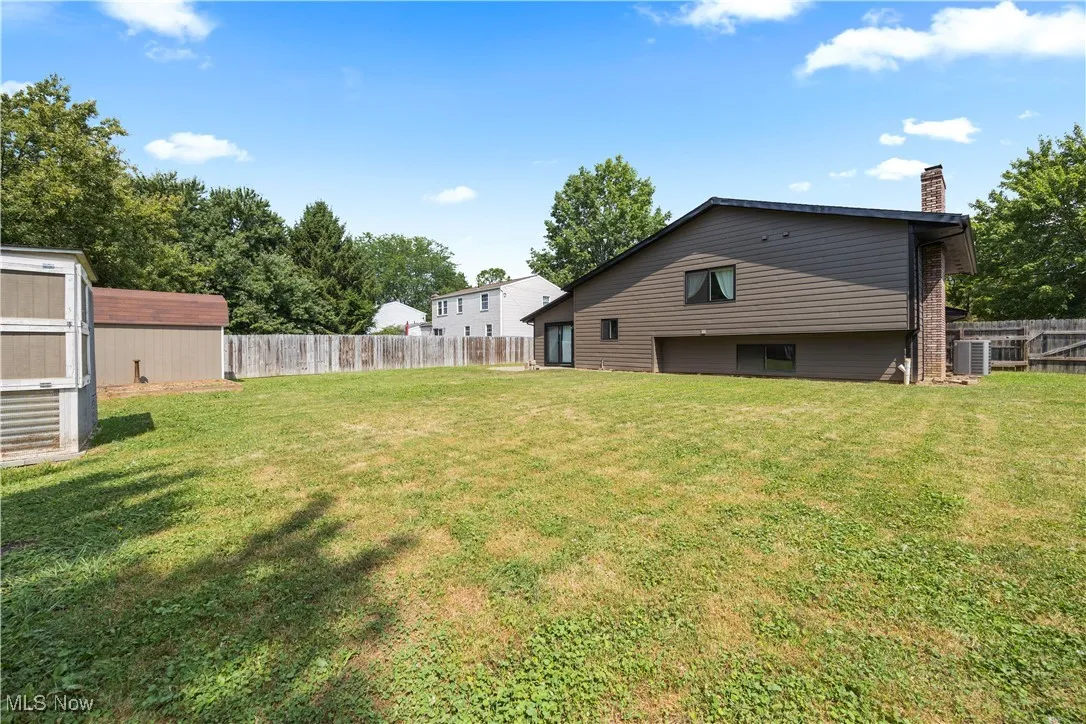 Fenced backyard with a storage shed
