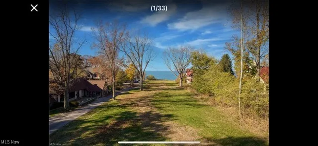 View of home's community featuring a water view and a lawn