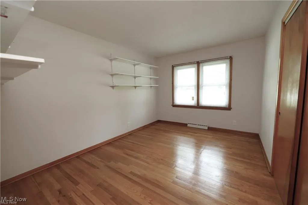 Unfurnished bedroom with a closet and light wood-type flooring