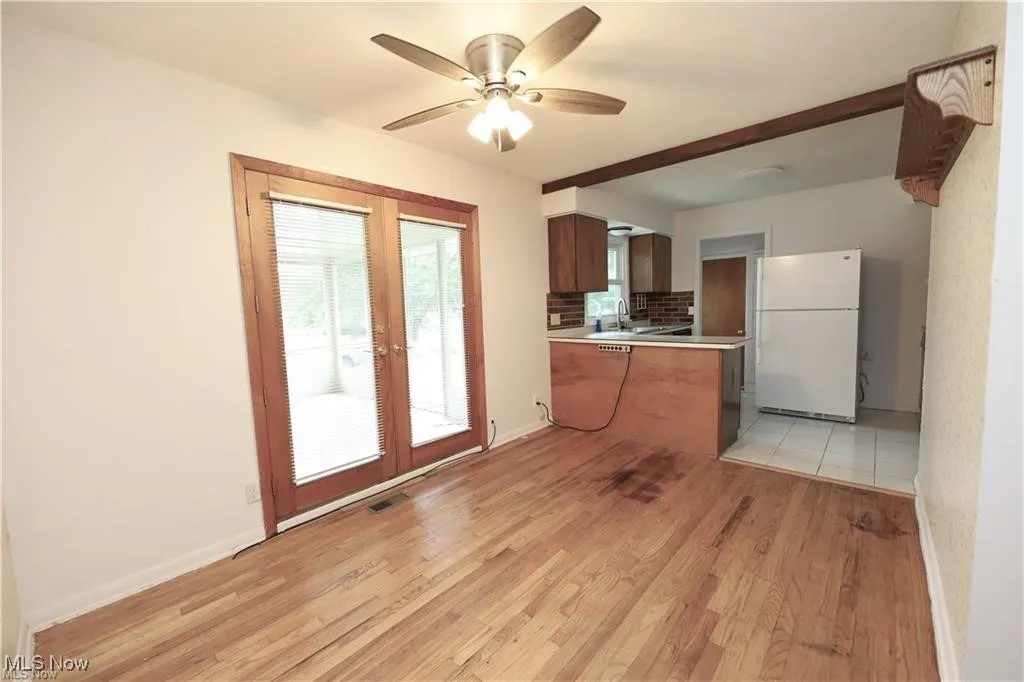 Kitchen featuring freestanding refrigerator, light countertops, plenty of natural light, and light wood-style floors