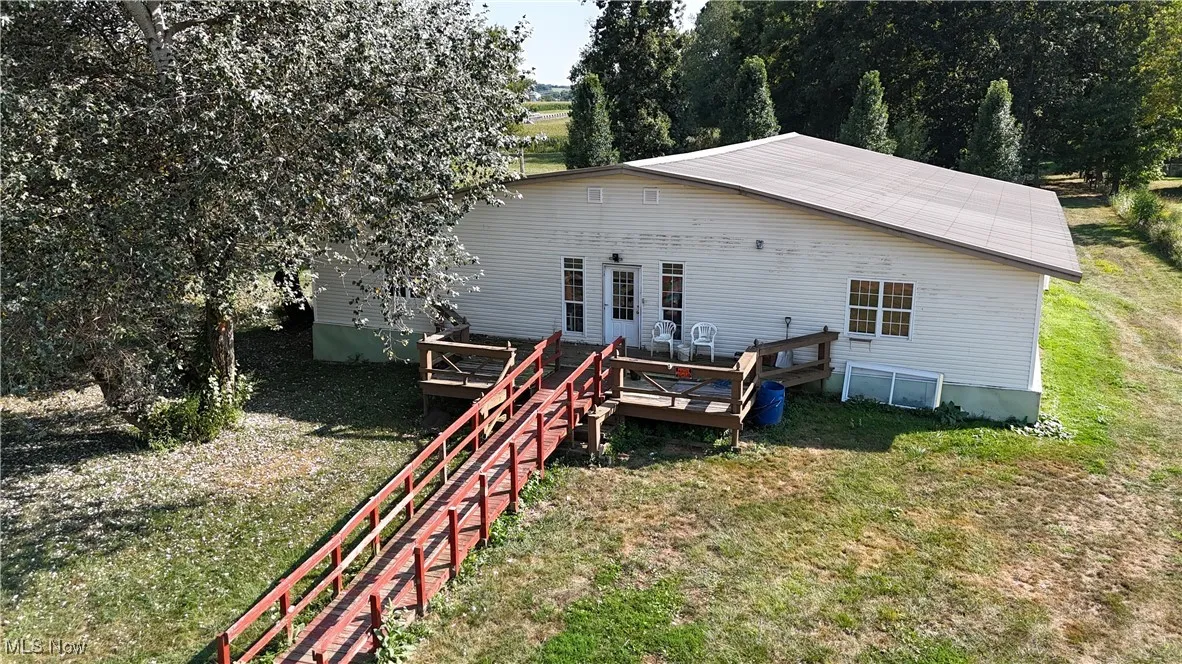 Back of house featuring a yard and a deck