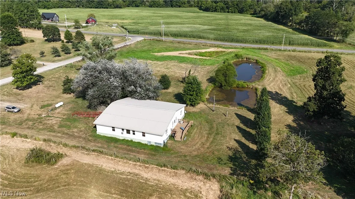 Overview of rural landscape featuring a large body of water and a tree filled landscape