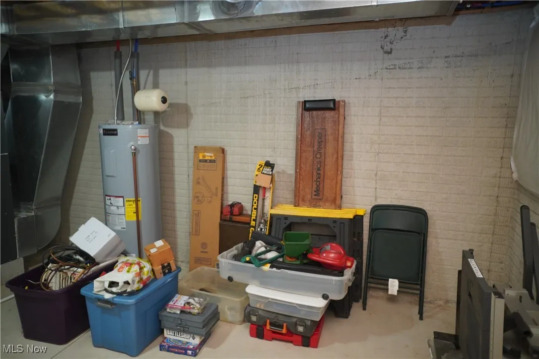 Garage featuring electric water heater and heating unit