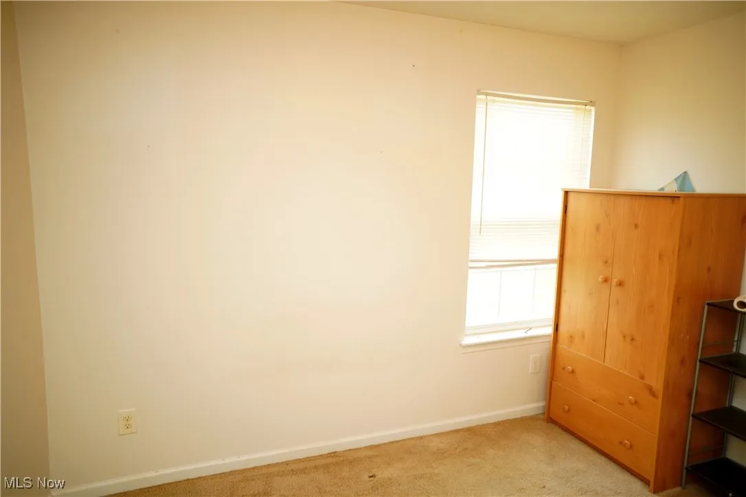 Unfurnished bedroom with light carpet