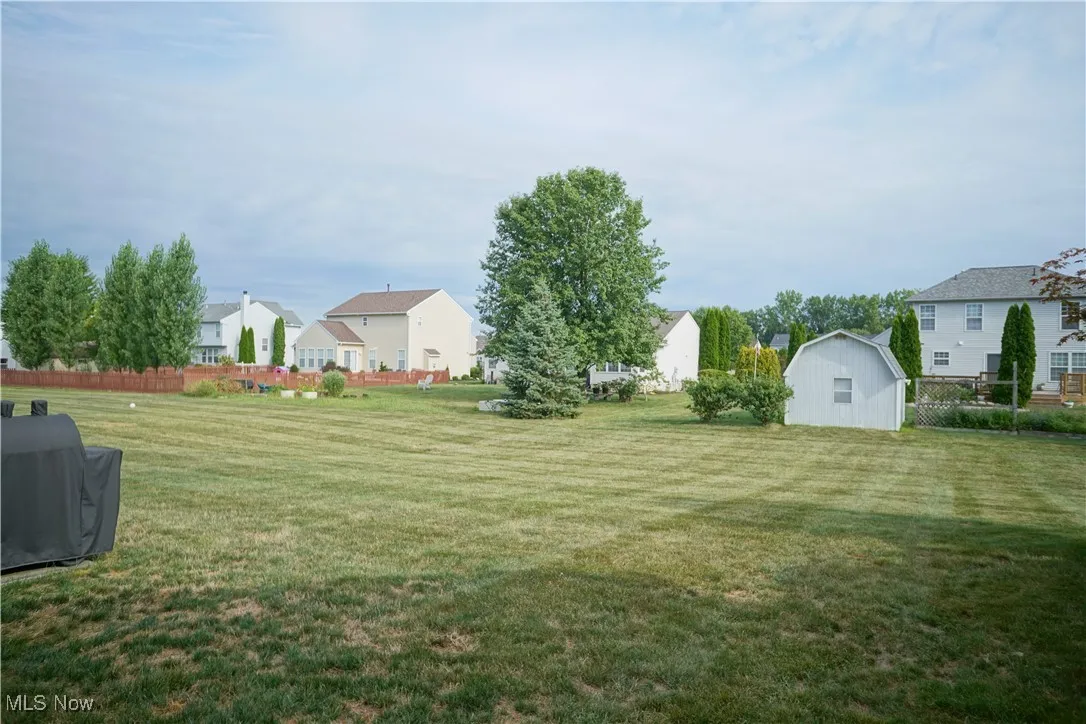 View of yard featuring a residential view and an outdoor structure
