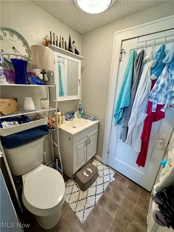 Bathroom with vanity and a textured ceiling