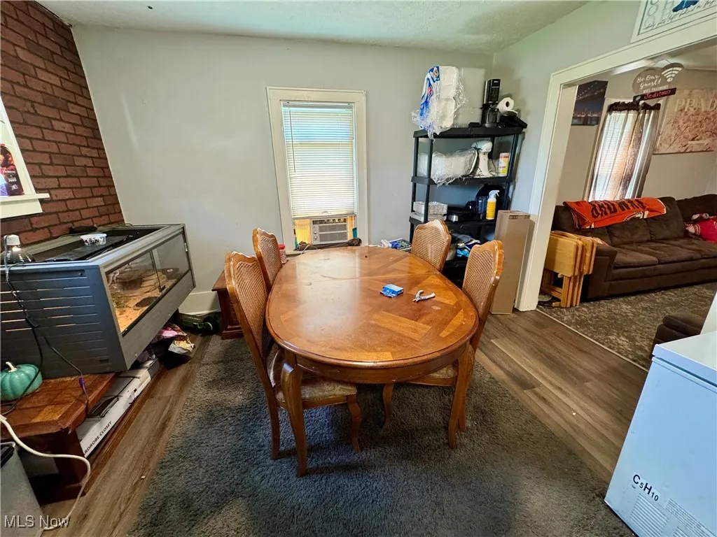Dining space with wood finished floors and a textured ceiling