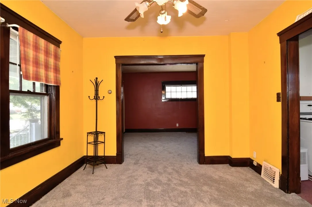 Hallway featuring carpet and baseboards