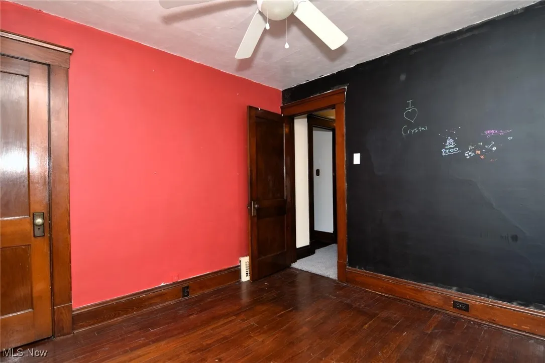 Empty room featuring hardwood / wood-style floors and a ceiling fan