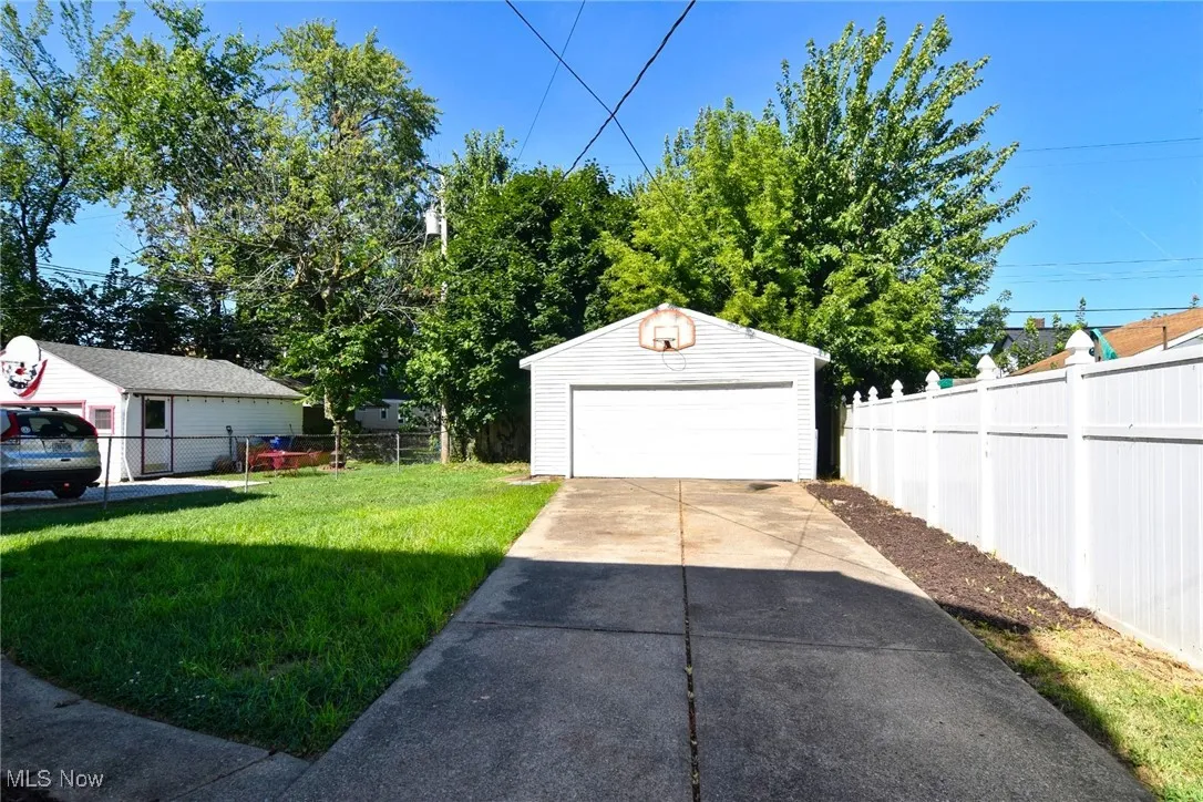 View of yard featuring an outbuilding and a detached garage