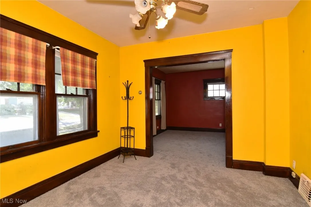 Carpeted empty room with baseboards