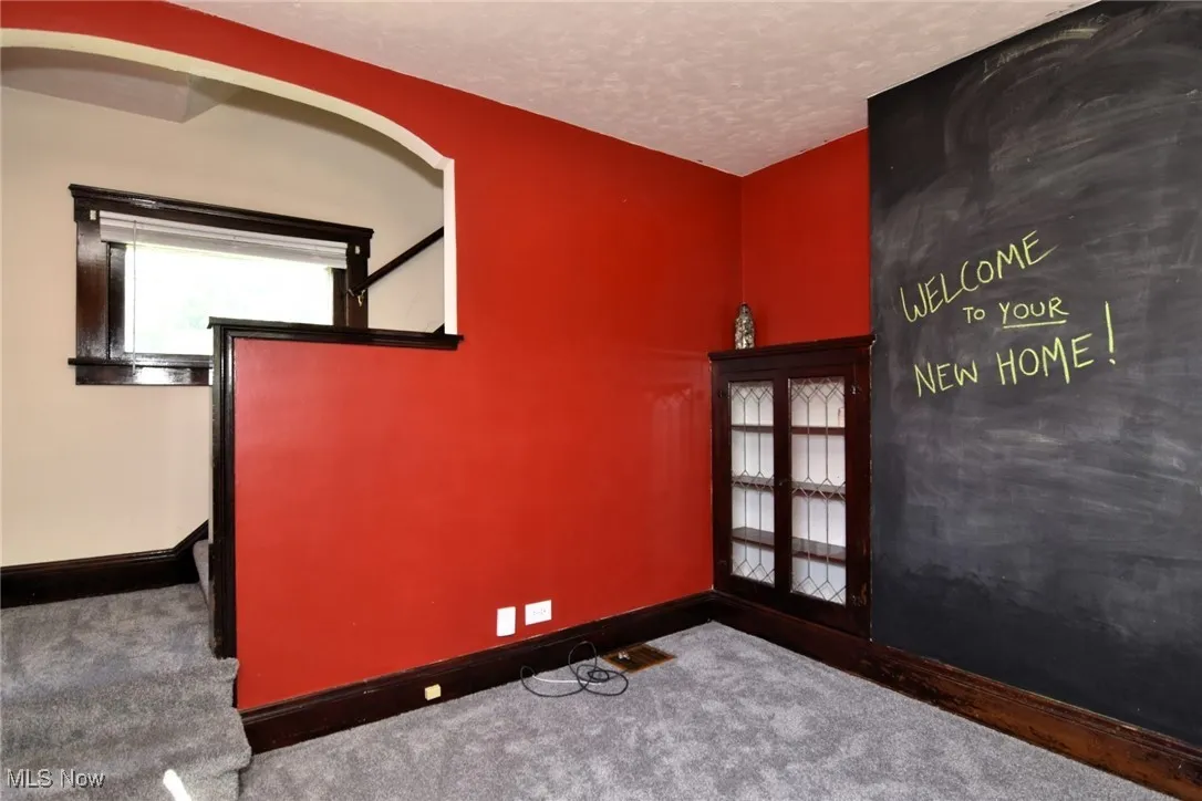 Empty room featuring carpet and a textured ceiling