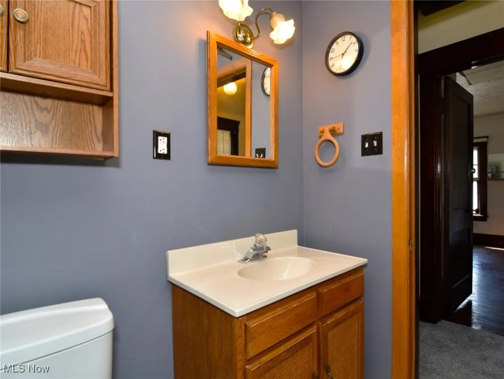 Half bathroom with vanity and a chandelier