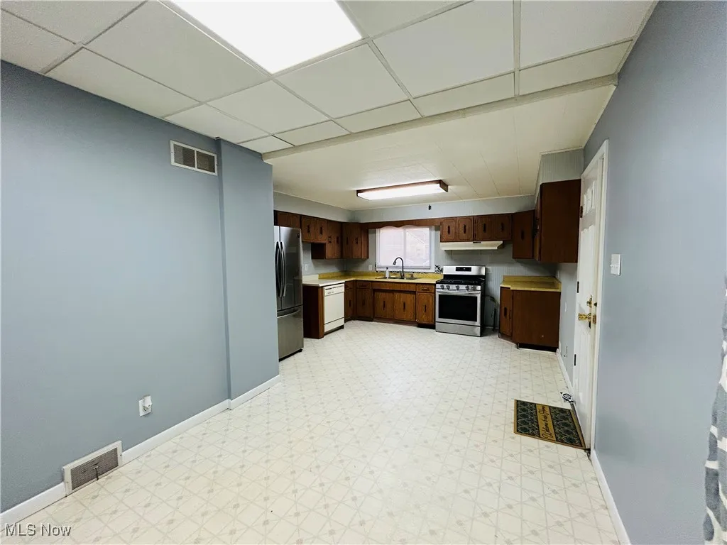 Kitchen with appliances, and cabinetry