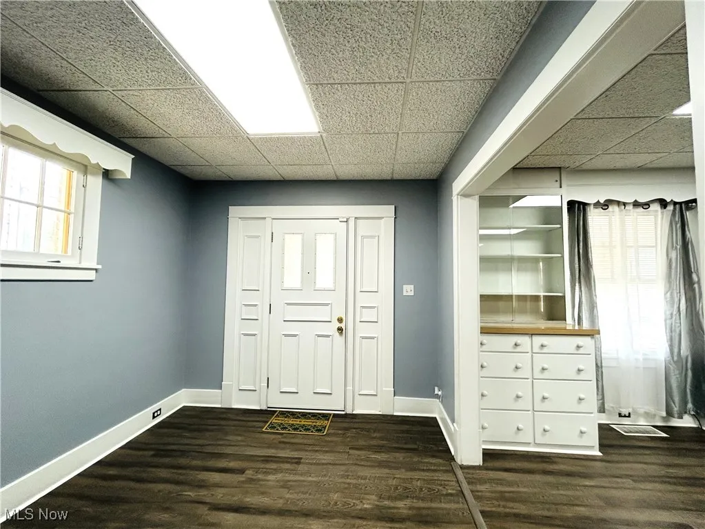 Foyer entrance featuring stairs and wood-style flooring