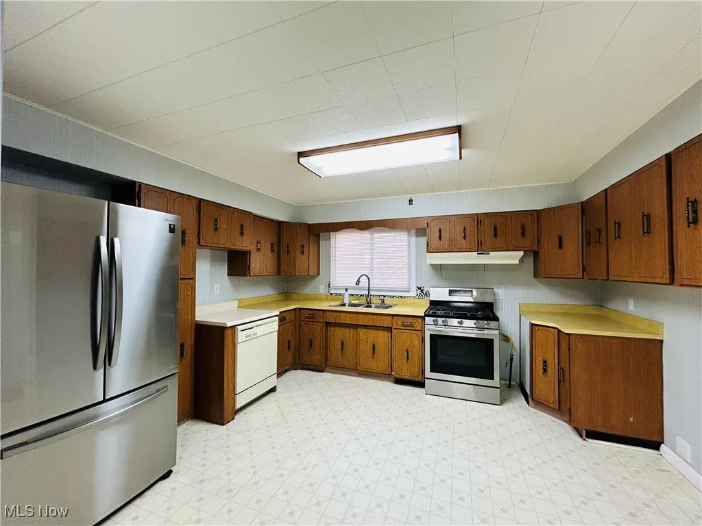 Kitchen with appliances and cabinetry