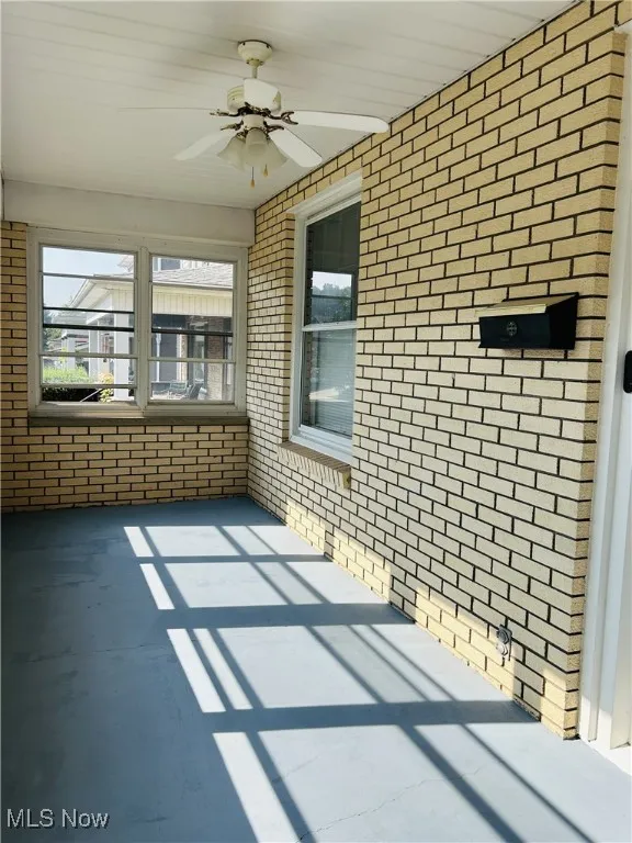 Sunroom featuring ceiling fan