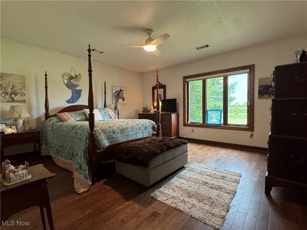 Bedroom featuring wood-type flooring and a ceiling fan