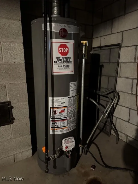 Utility room featuring gas water heater