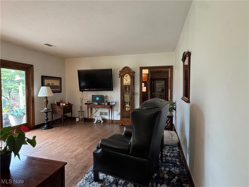 Living room featuring wood finished floors and a textured ceiling