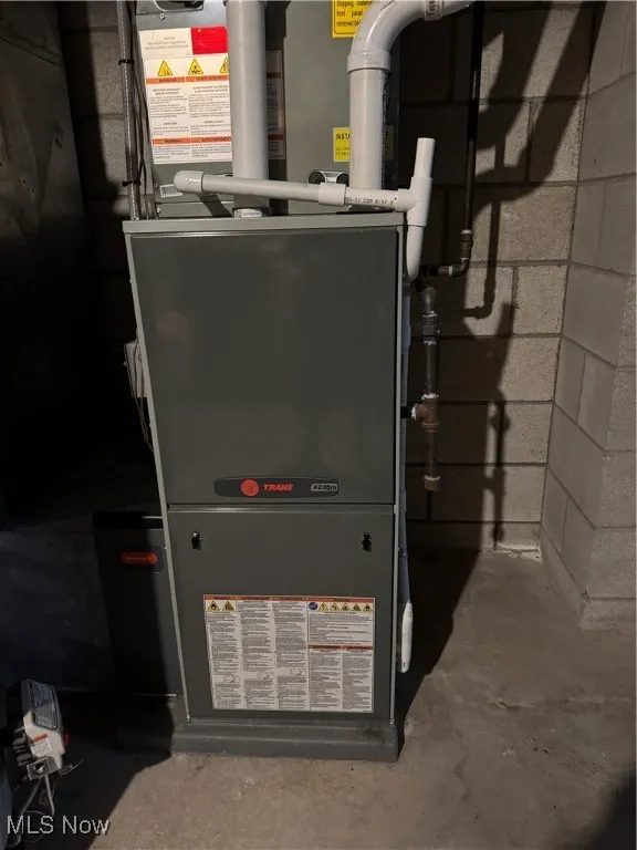 Utility room featuring heating unit