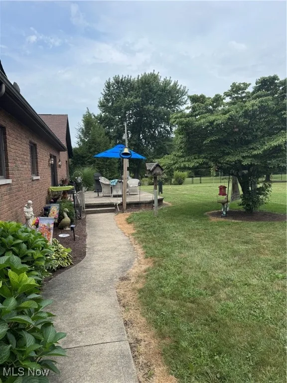 View of community featuring a deck and a lawn