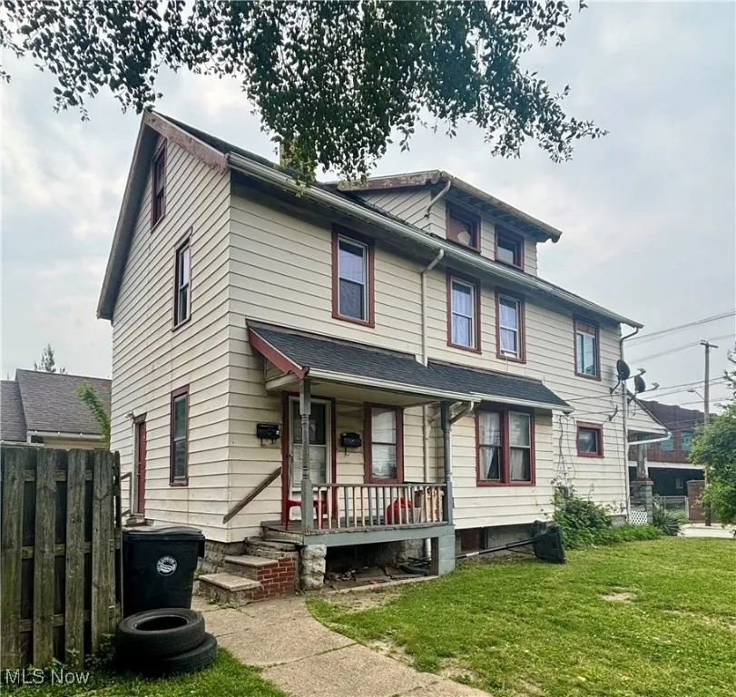 American foursquare style home featuring covered porch