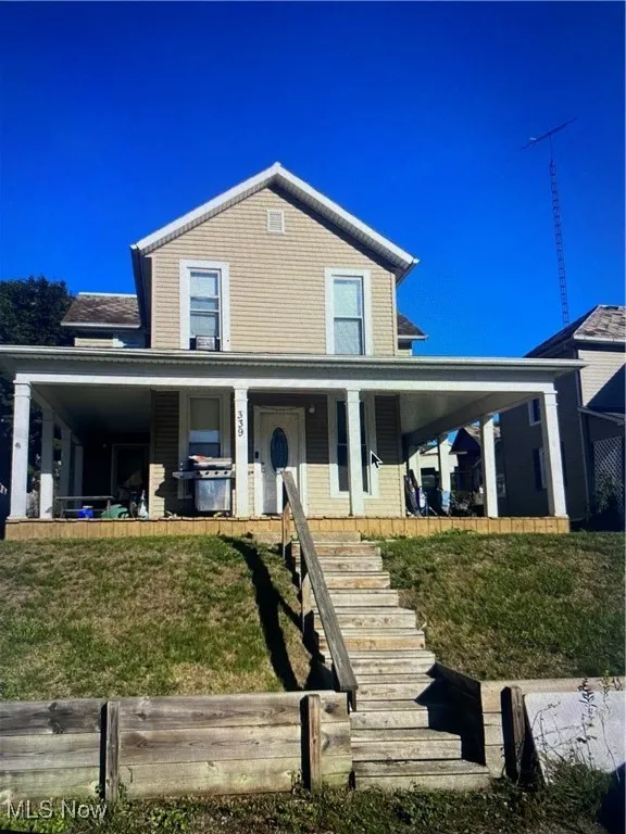 Farmhouse featuring a front yard and a porch