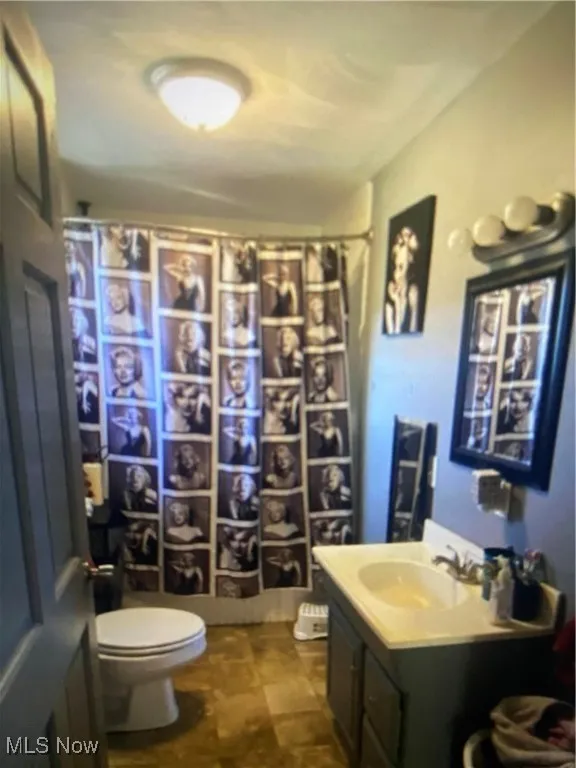 Full bathroom with vanity and curtained shower