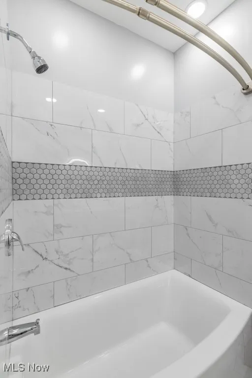 Beautifully tiled tub surround.