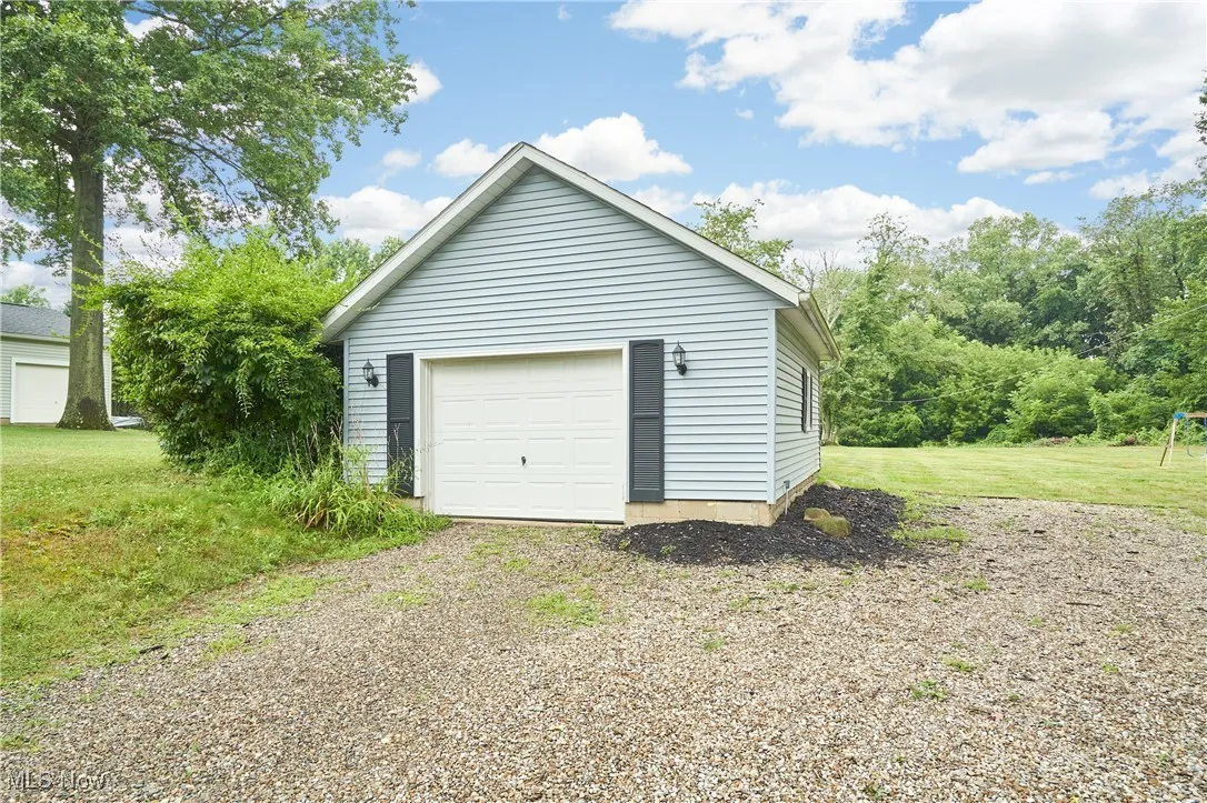 Detached garage with gravel driveway